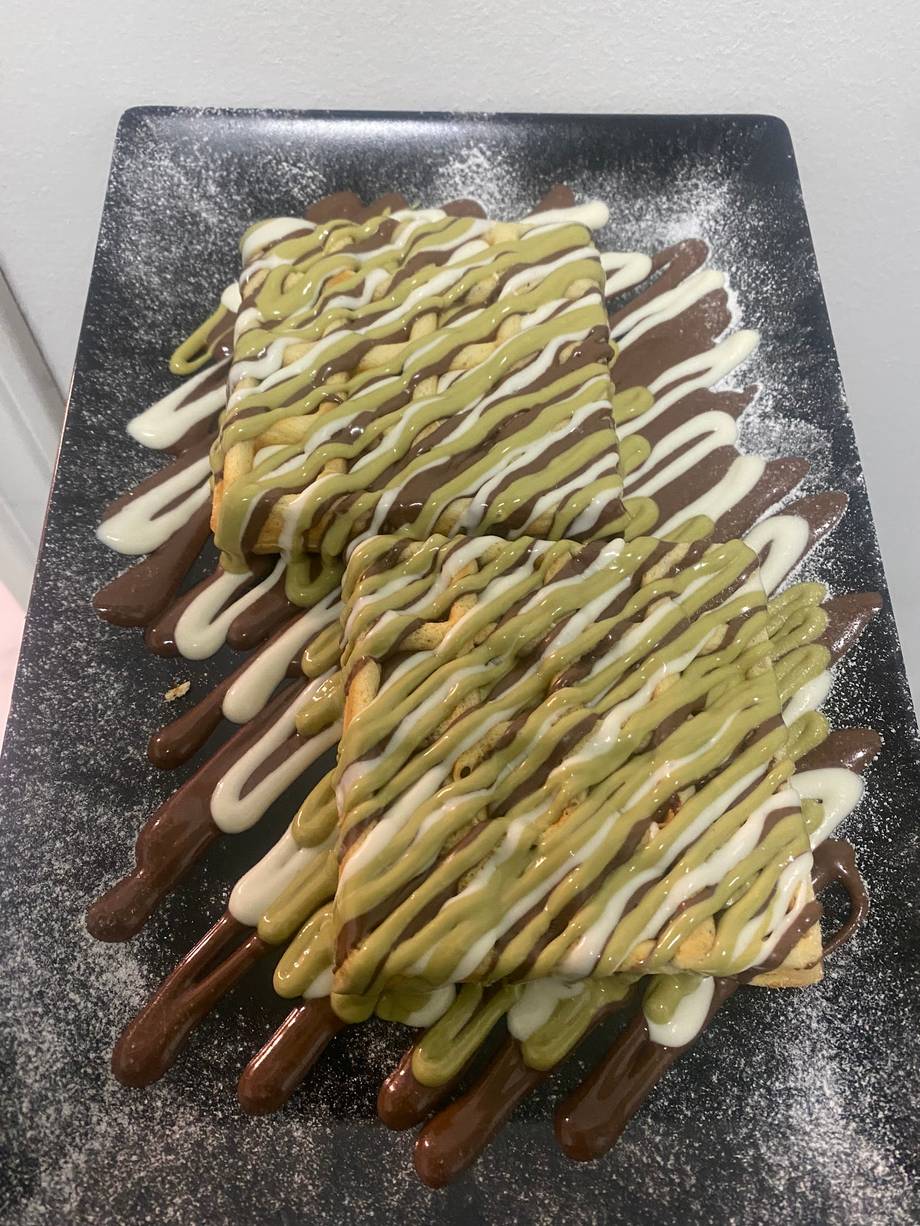 Chocolate-dipped wafers with pistachio and white chocolate drizzle