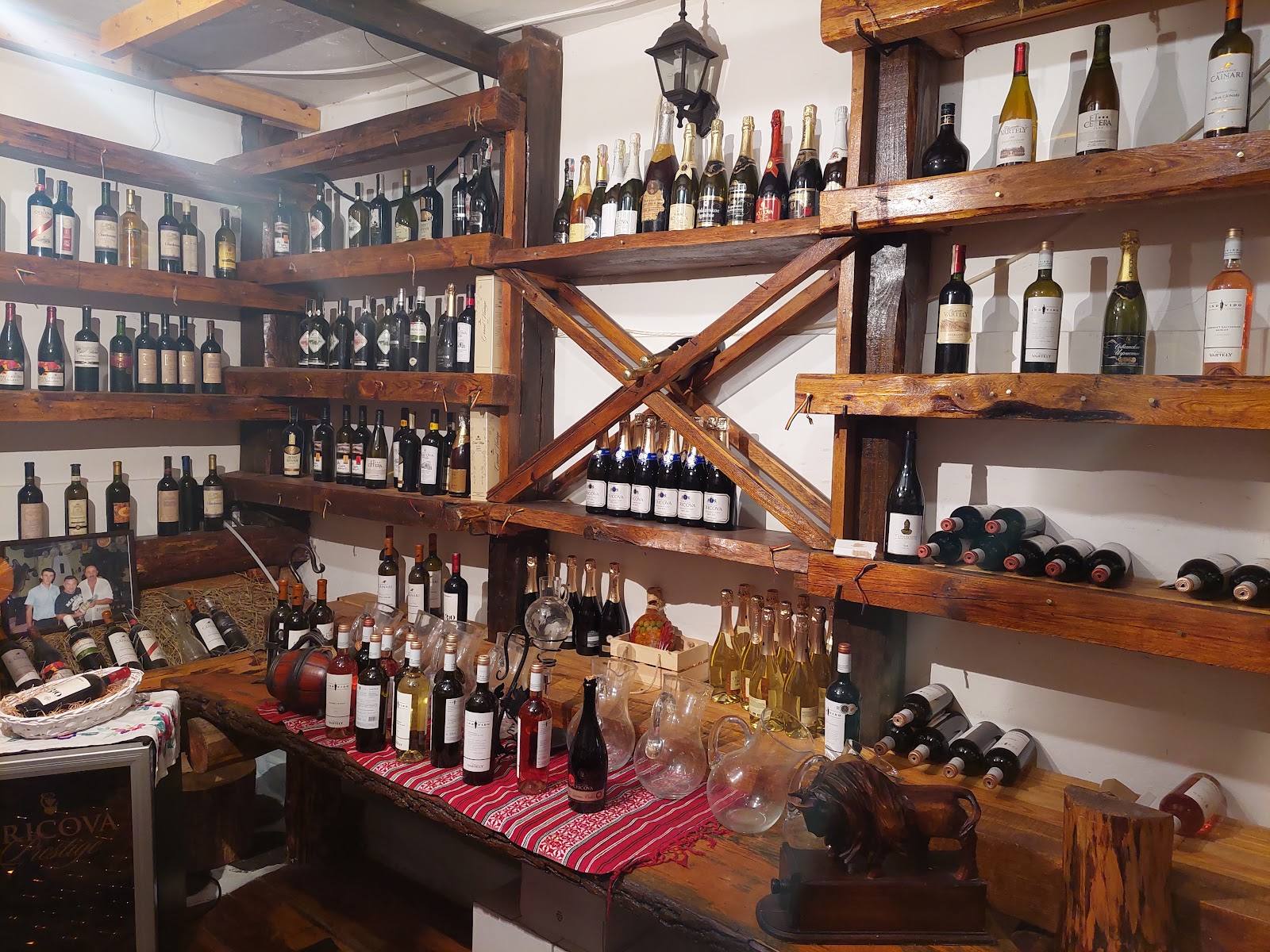 Rustic wine shop interior with wooden shelving displaying bottles and wine selection