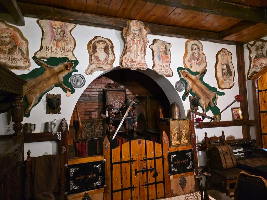 Traditional wine cellar interior with barrel arch, hunting trophies, and rustic wooden decor