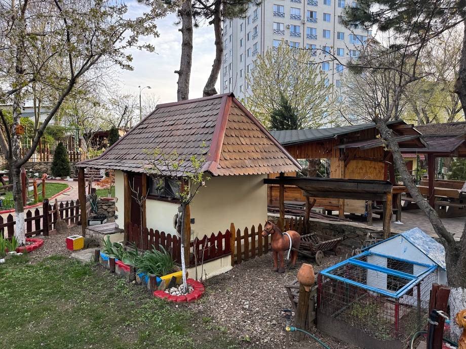 Traditional wooden cottage venue with peaked roof and outdoor courtyard seating area