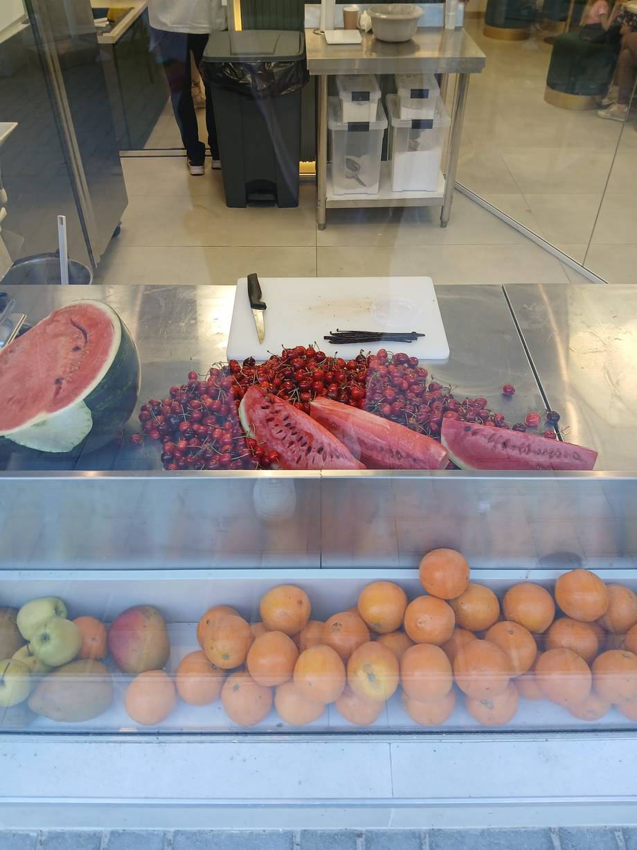 Close-up of fresh berries and produce in refrigerated display case